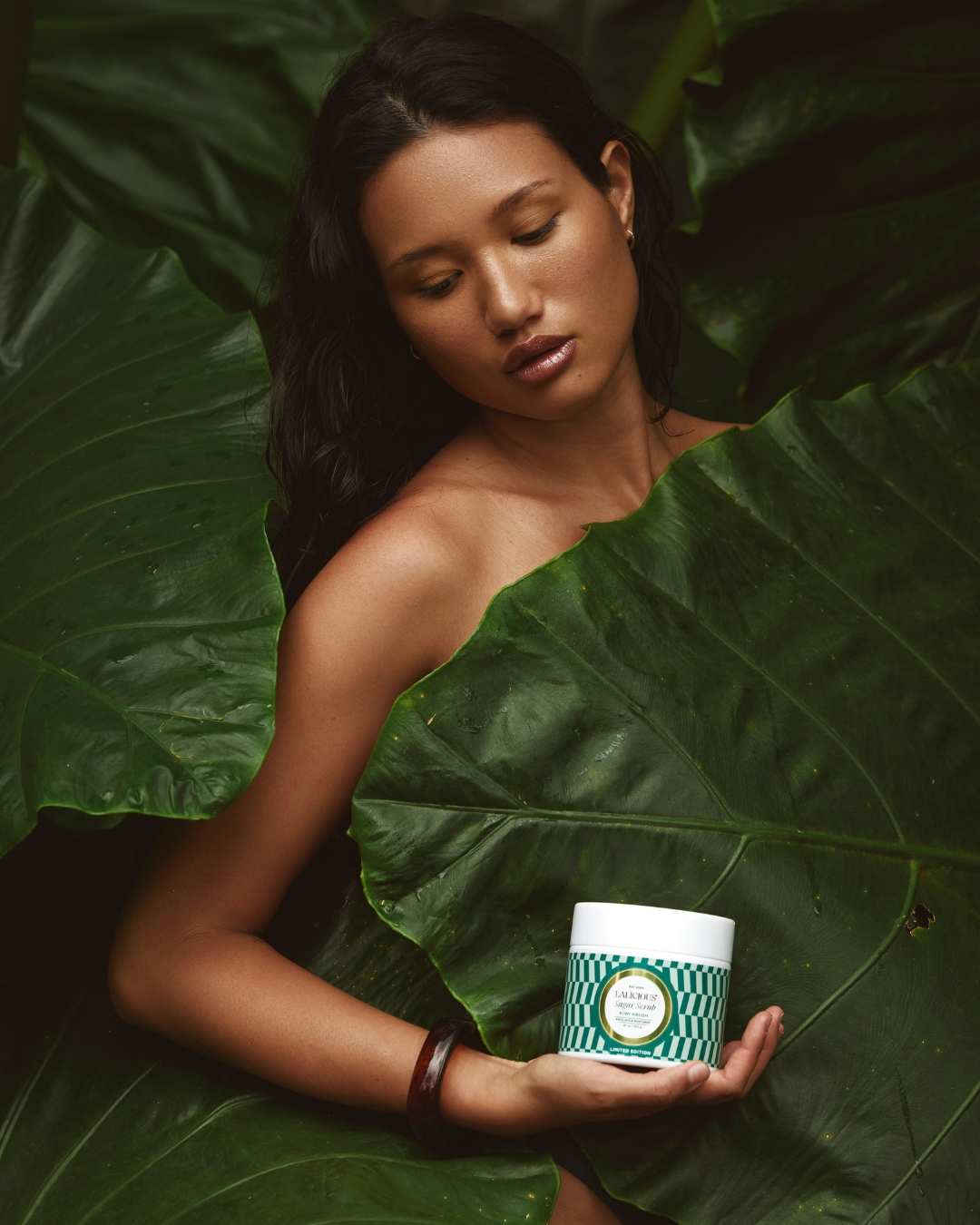 Woman exfoliating her arm for smooth, hydrated summer skin.