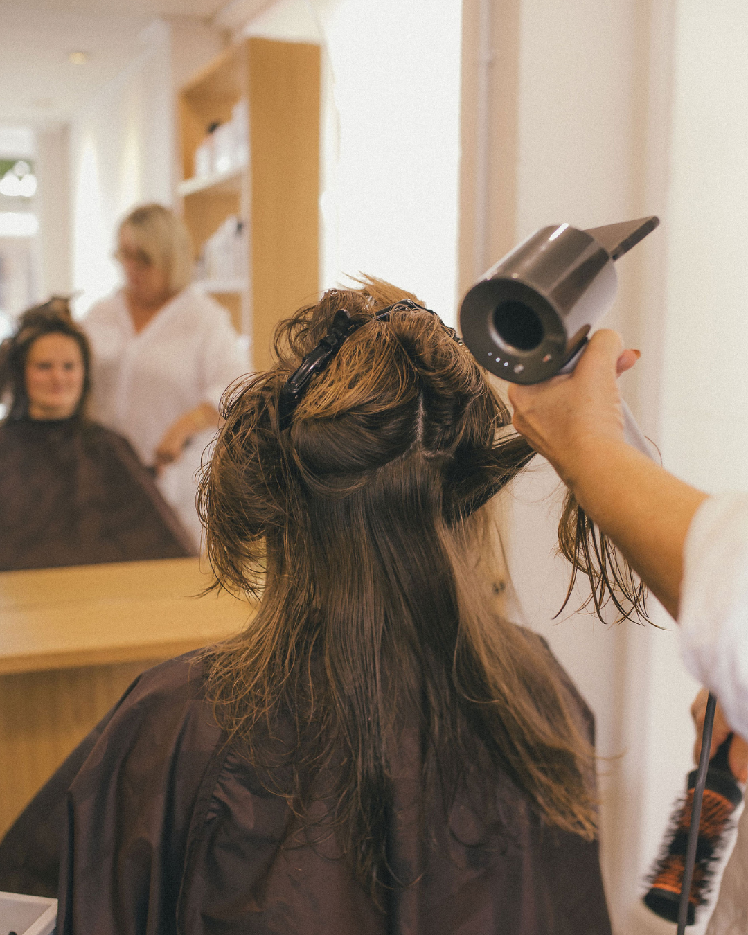 Hair stylist for a speedy dry treatment at Reveal Mount Maunganui salon