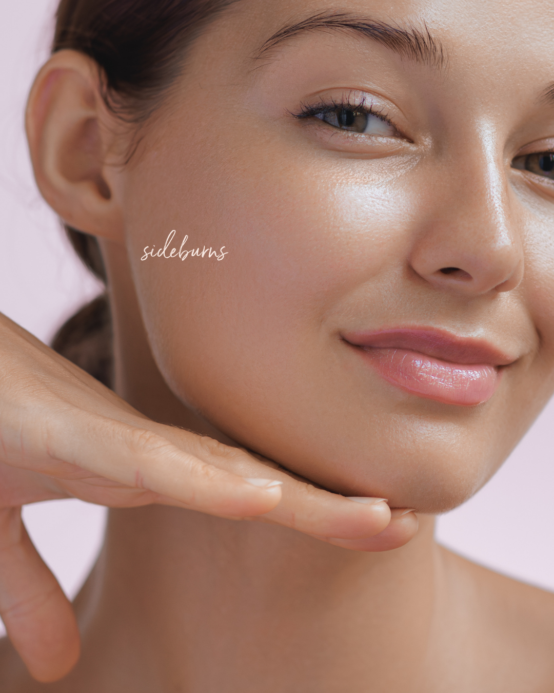 Close-up of the side of a woman's face with smooth skin along the hairline.